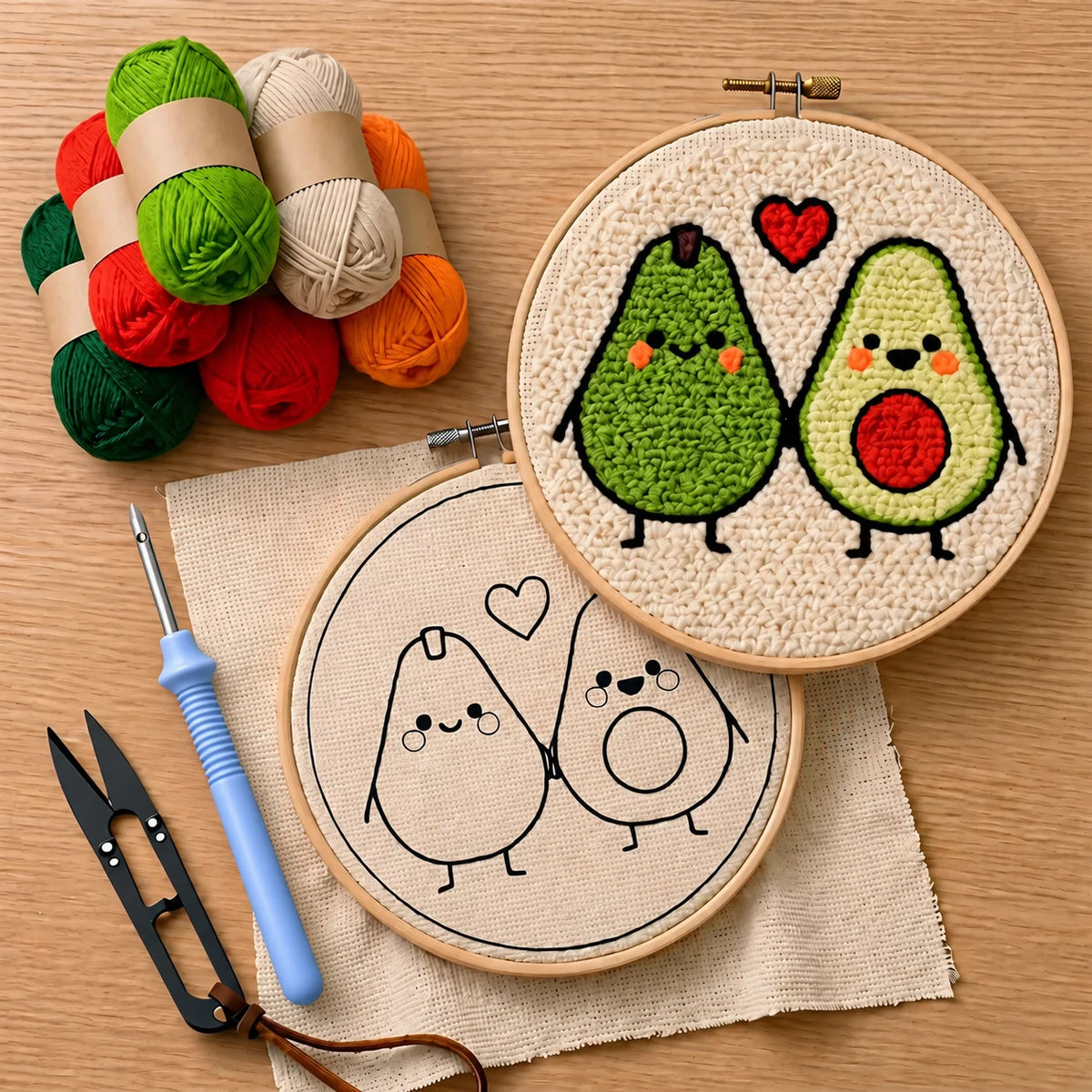 Embroidery hoops with avocado-themed punch needled designs and colorful yarns, thread cutter, punch needle on a wooden surface
