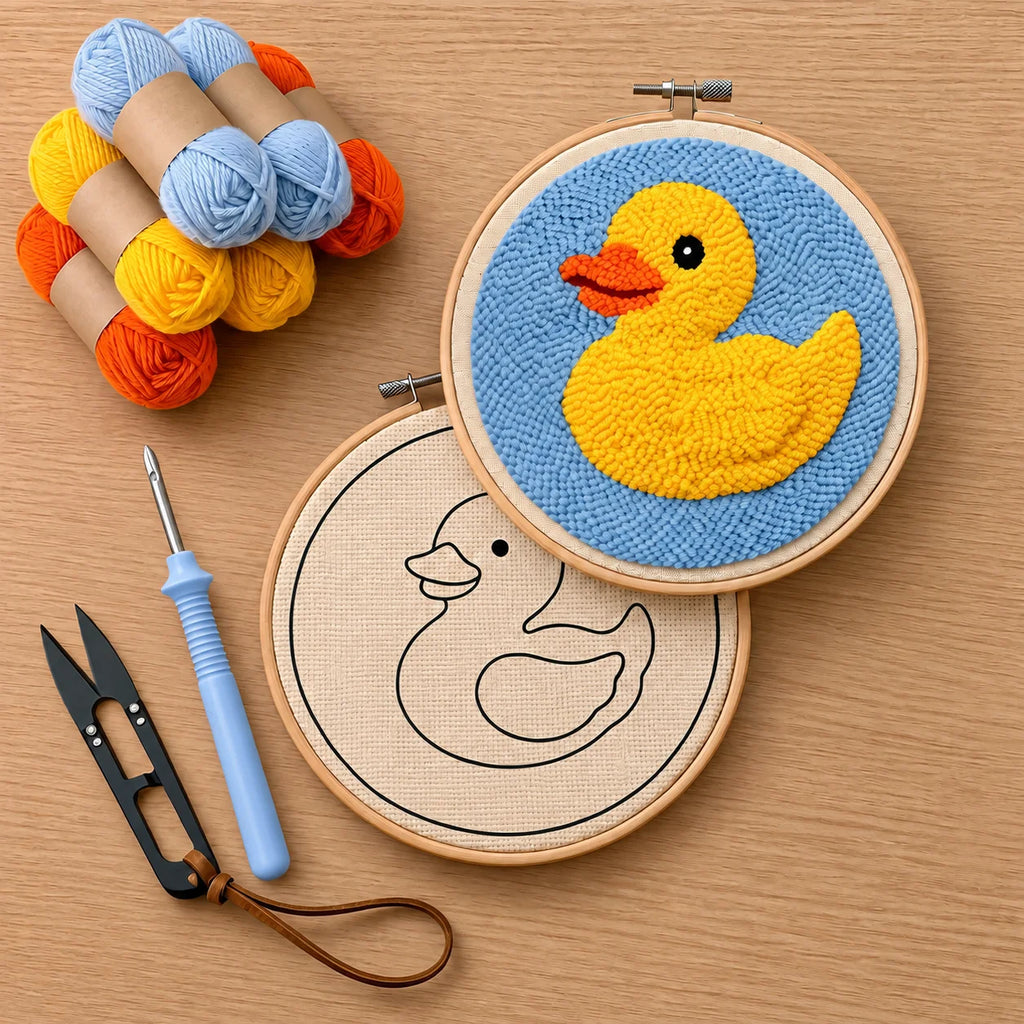 Embroidery hoop with a yellow duck design, skeins of yarn, and punch needle embroidery tools on a wooden surface.