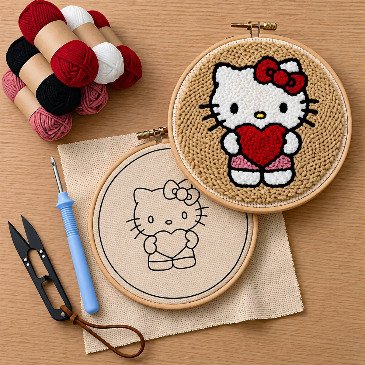 Embroidery hoop with Hello Kitty design on a wooden surface with yarn and punch needle tools.