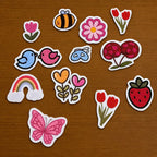Garden-themed stitch and stitch stickers on wooden surface