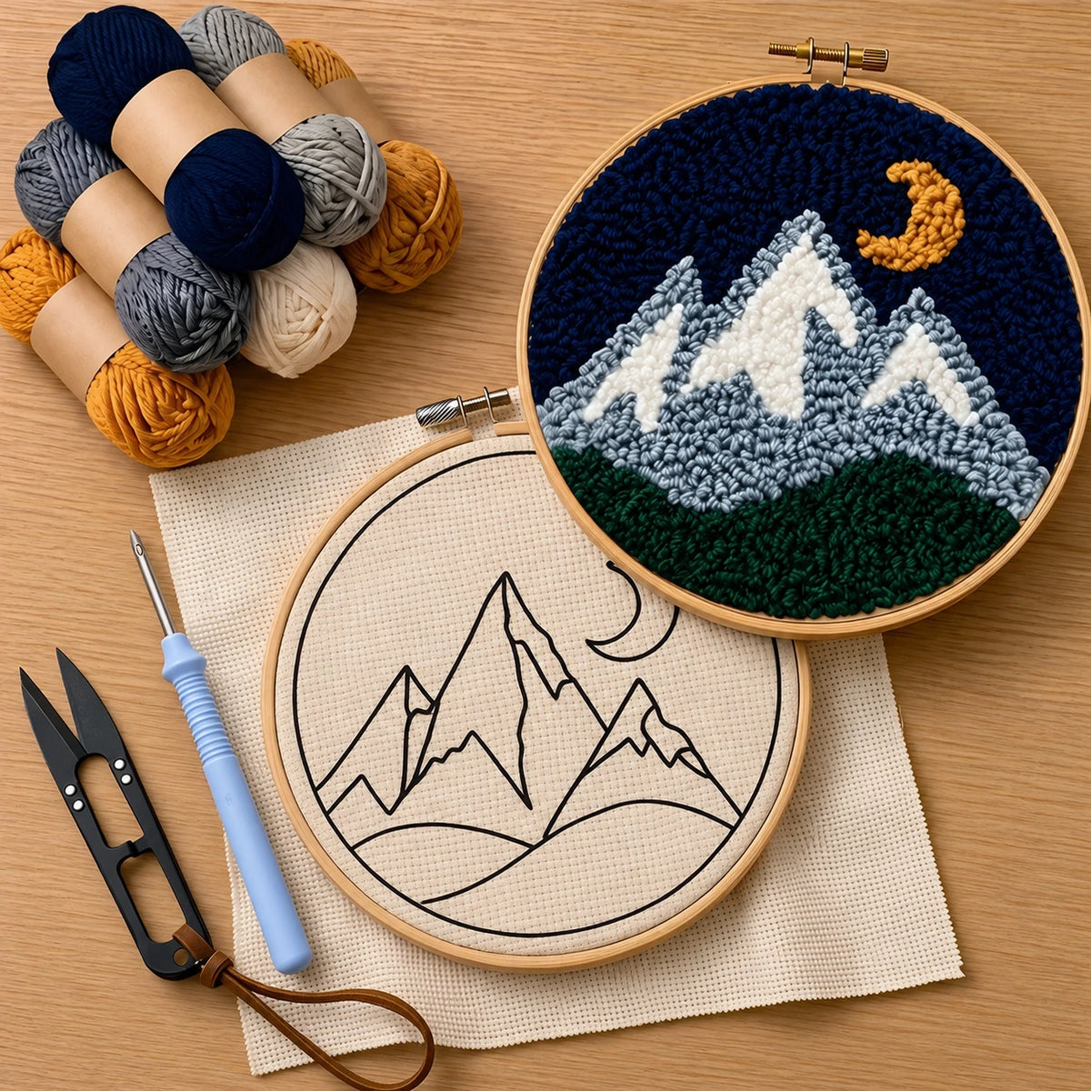 Embroidery hoop with mountain design punched on monk cloth, yarn, scissors, and thread cutter ,punch needle on a wooden surface