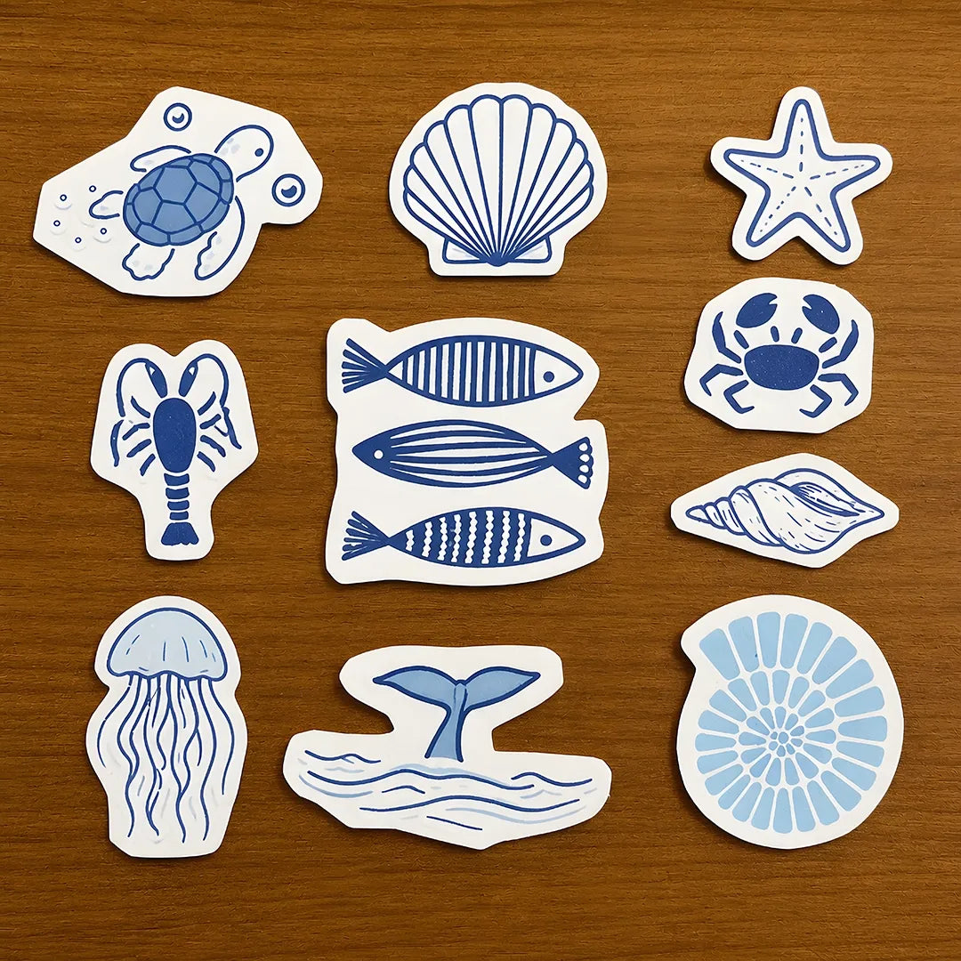 Collection of ocean stitch and stitch stickers on wooden surface