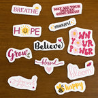 Motivational stick and stitch stickers with phrases like 'Breathe', 'Hope', 'Believe', and more on a wooden surface.
