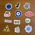 Collection of streetwear fashion stitch and stitch stickers  on a wooden surface