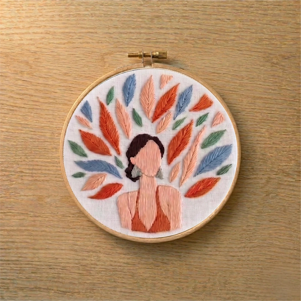 Embroidery hoop with a colorful floral design on a wooden surface