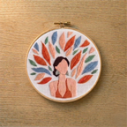 Embroidery hoop with a colorful floral design on a wooden surface