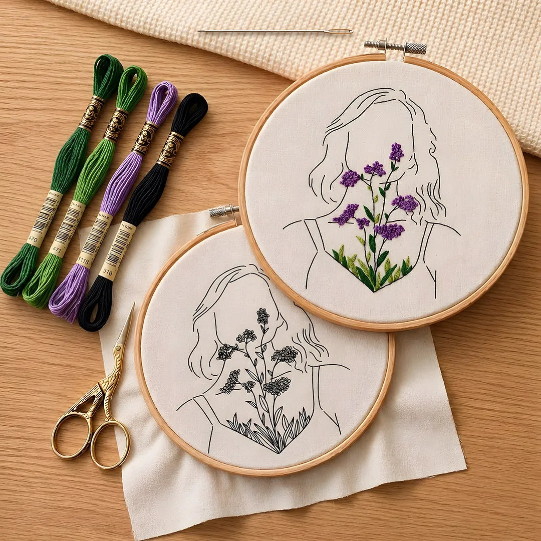 Embroidery hoops with floral designs ,woman face and embroidery threads on a wooden surface