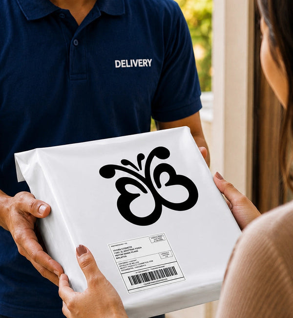 Person receiving a package from a delivery person wearing a blue 'Delivery' shirt.